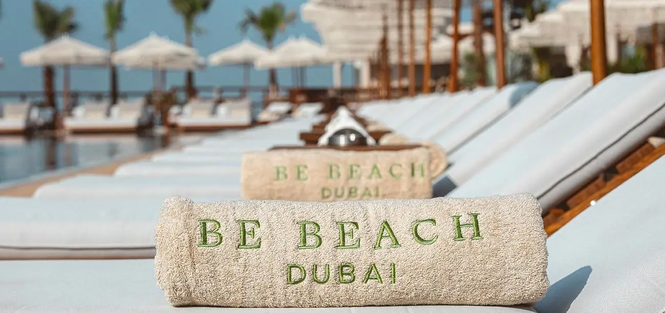 Be Beach-branded towels beside the pool