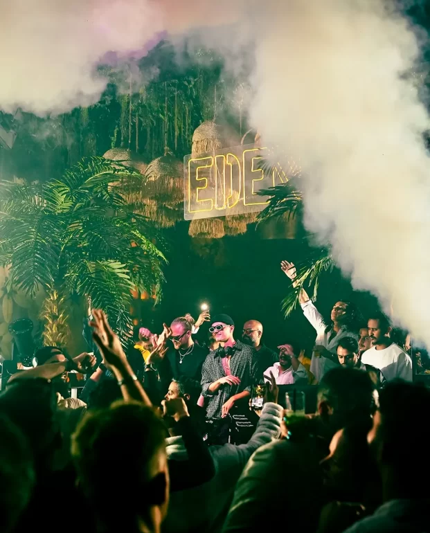 Guests in front of illuminated CAVO signage during an earlier night