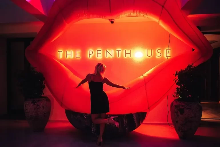A guest seen from behind beneath The Penthouse sign at FIVE Palm Jumeirah