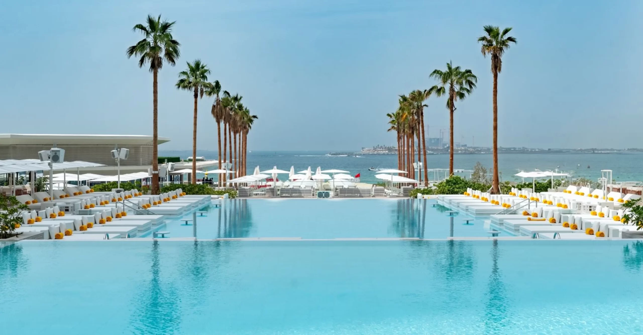 Palm-lined beachfront pool at Playa Pacha, FIVE LUXE JBR